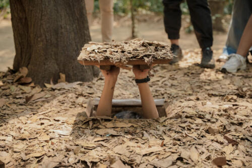 Cu Chi Tunnels. Tourists try to enter the underground tunnels. These tunnels were used in the Vietnam war. Famous tourist attractions in Vietnam