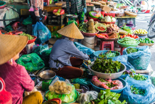 Women selling food on the street of Hoi An, Vietnam