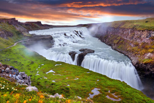 Panoramic view on Gullfoss waterfall on the Hvíta river, a popular tourist attraction and part of the Golden Circle Tourist Route in Southwest Iceland. Golden Waterfall. Travelling concept background.