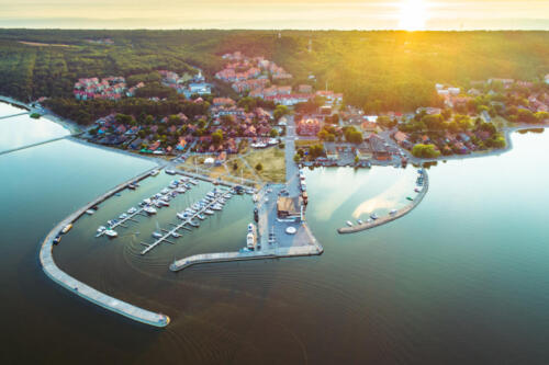 Nida city evening aerial view with yacht pier and forests in Curonian spit, Lithuania