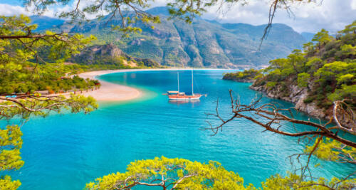 Brown gulet anchored at the Aegean sea - Panoramic view of Oludeniz Beach And Blue Lagoon, Oludeniz beach is best beaches in Turkey - Fethiye, Turkey