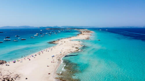 Aerial view of the beaches of Ses Illetes on the island of Formentera in the Balearic Islands, Spain - Turquoise waters on both sides of a sand strip in the Mediterranean Sea