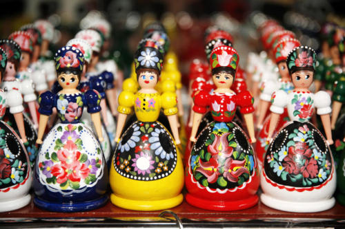 Wooden dolls in hungarian folk costumes as souvenir in row